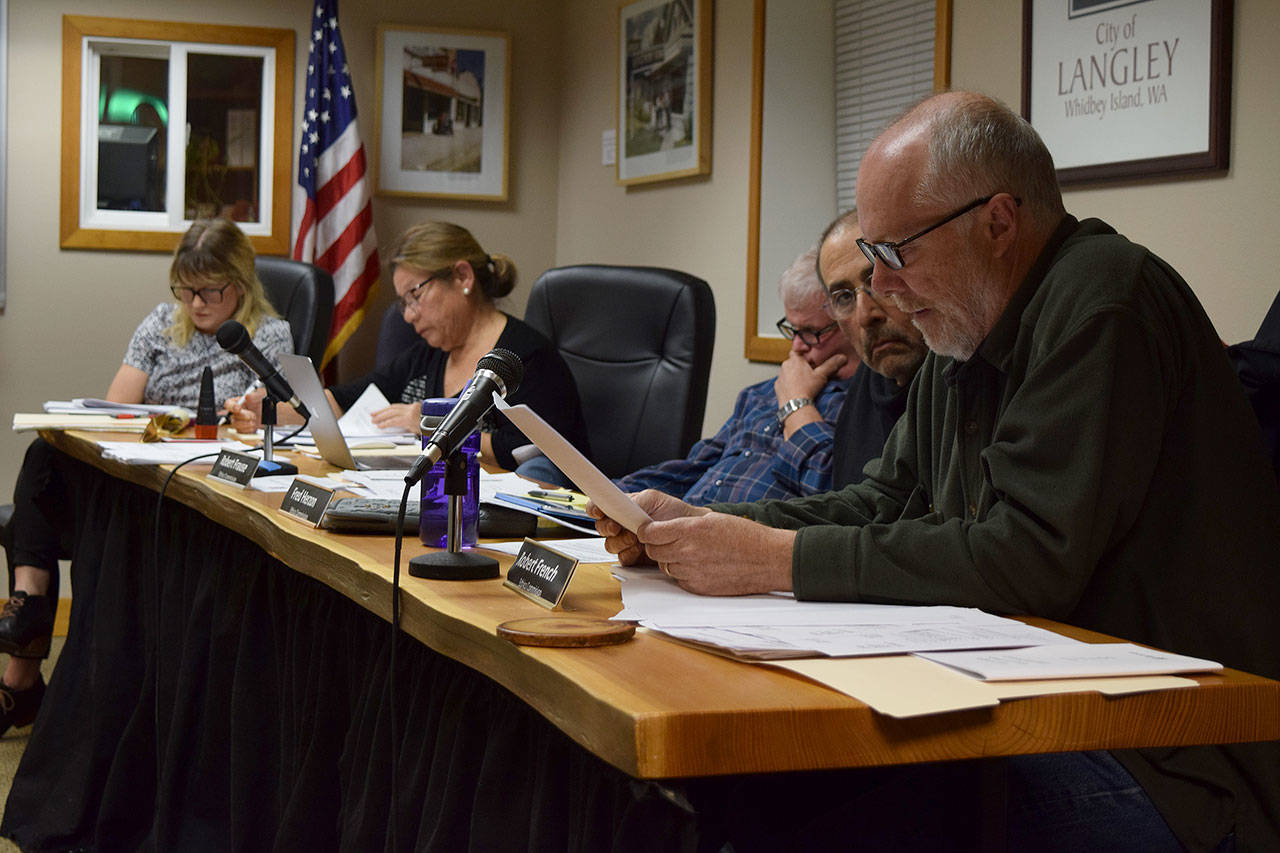Kyle Jensen / The Record — Langley Ethics Training and Advisory Board member Bob French reads an advisory opinion. The board determined its own member, Monica Guzman, wasn’t unethical when she branded Langley city council candidate Burt Beusch as a Donald Trump supporter in a public forum.