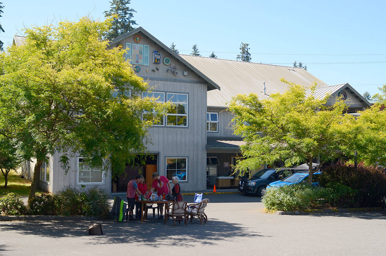 Record file  Island Senior Resources and Senior Thrift employees gather at a make-shift office in the thrift shops parking lot in July. The store has been closed since a fire damaged the building, but it will reopen on Black Friday.