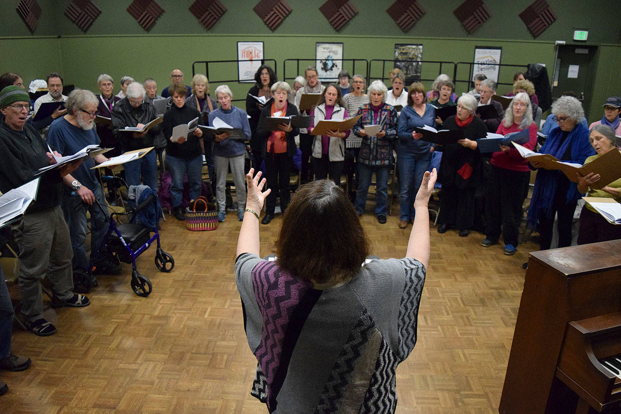 Kyle Jensen / The Record — Conductor Peggy Taylor leads Open Circle Singers during a practice session on Monday, Nov. 20.