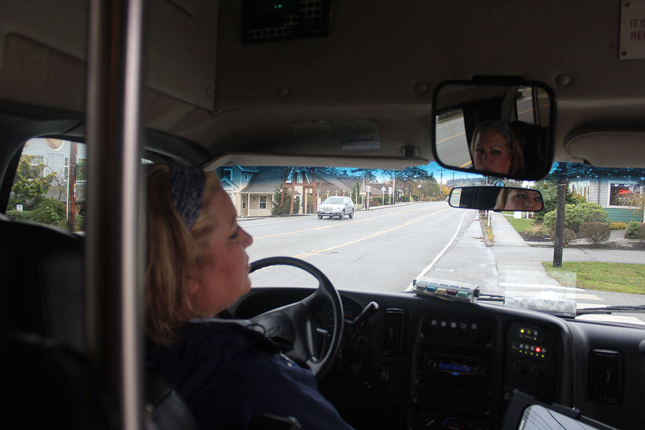 Teresa Davis, known as T to her bus riders, says she enjoys her Island Transit driving job for the variety of routes she serves. The company celebrates 30 years Friday. Photo by Patricia Guthrie/Whidbey News-Times