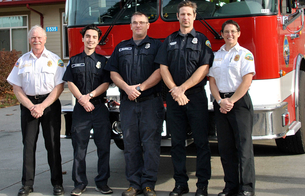 Contributed photo — South Whidbey Fire/EMS welcomed three new volunteers to its team. Left to right: Chief Rusty Palmer, Langley resident Al Charat, Clinton resident Carl Hillegas, Freeland resident John LeDrew and Deputy Chief Wendy Moffatt.