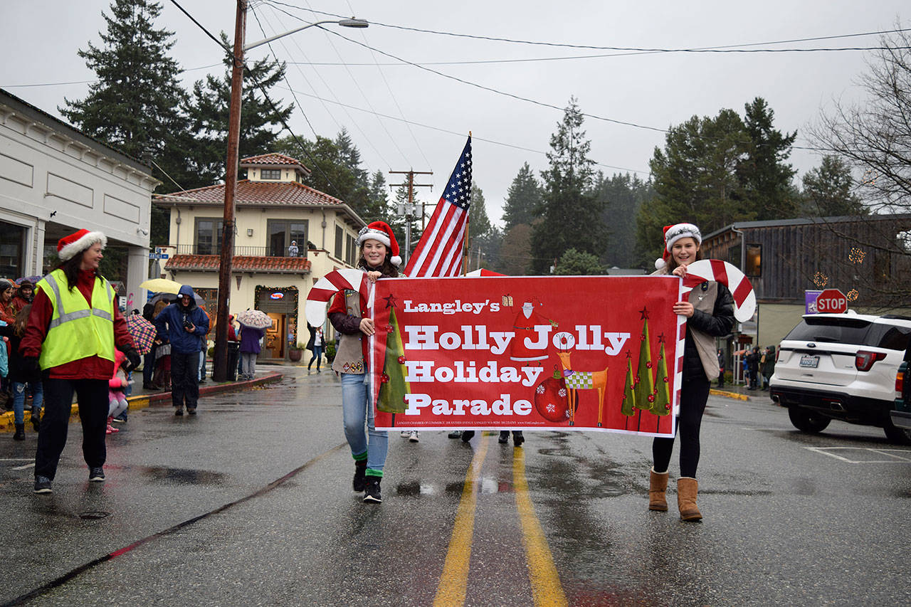 Kyle Jensen / The Record — Despite the downpour and brisk temperatures, marchers happily strolled through town to bring the Christmas cheer to Langley.
