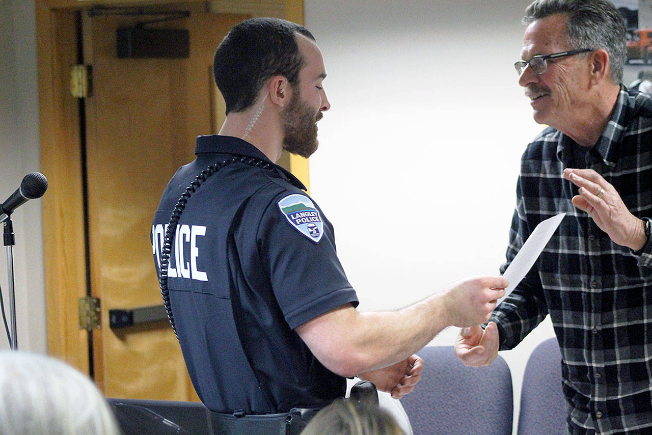 Evan Thompson / The Record — Langley Police Officer Mason Shoudy was given special recognition by Mayor Tim Callison on Monday night for his role in catching a suspect in two armed robberies of Naomi’s Mobil gas station in Clinton.