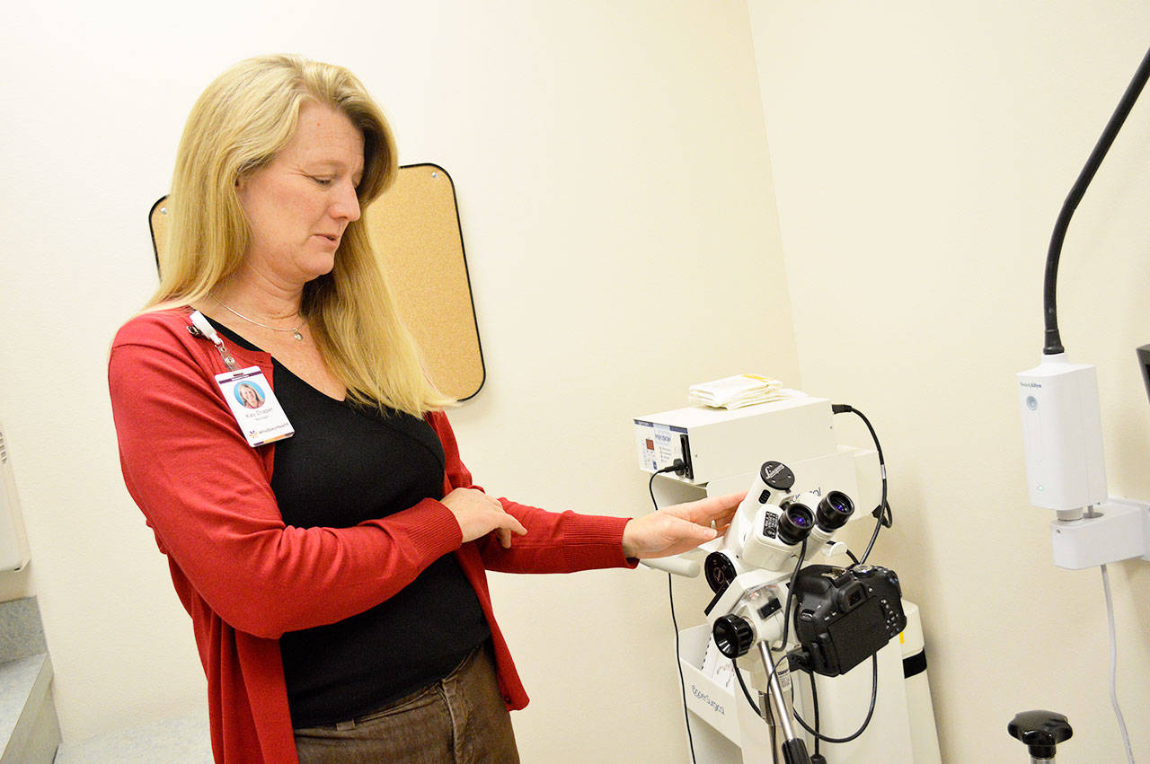 Kay Draper, clinic manager of the new WhidbeyHealth Women’s Care clinic in Oak Harbor explains the colposcope, which is used to exam the cervix. All the equipment in the clinic is new and was paid for by the WhidbeyHealth Foundation. Photo by Laura Guido/Whidbey News-Times