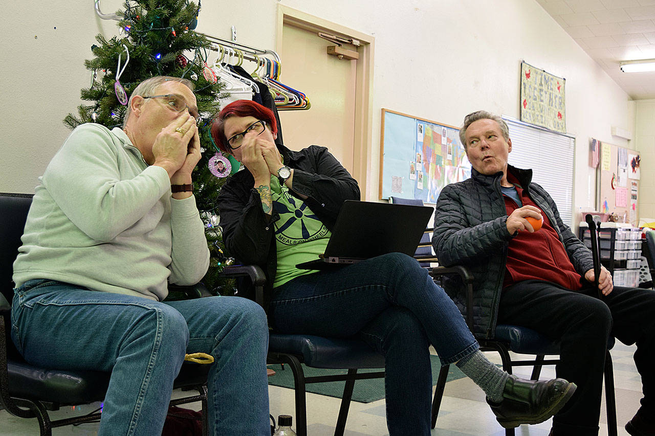 Kyle Jensen / The Record — Scott Martin (left) and class organizer Mel Watson (center) pretend to play the harmonica while John Raabe (right) sings.