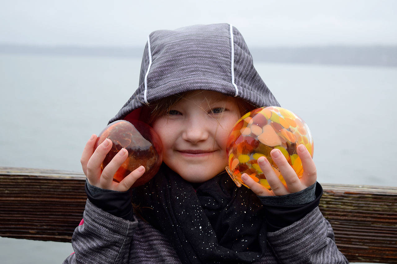 Kyle Jensen / The Record — Olive Stieber, a 7-year-old Seattle resident, shows off her finds at the Sea Float Scramble. She says she picked a second up for her dad, who couldn’t attend.
