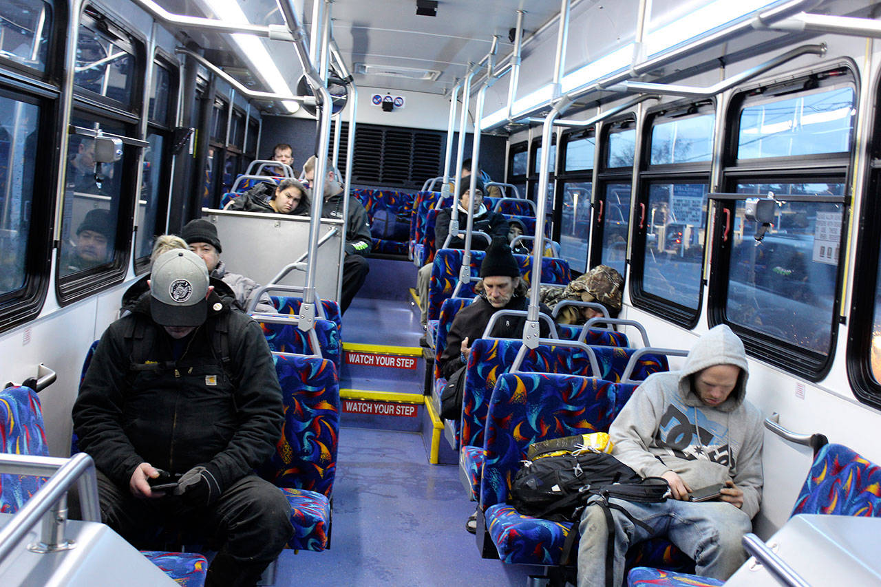 Morning commuters look at a lot of little screens during their southbound trip Tuesday morning. Island Transit announced it’s resuming Saturday bus service, beginning Jan. 27. Photo by Patricia Guthrie/Whidbey News-Times