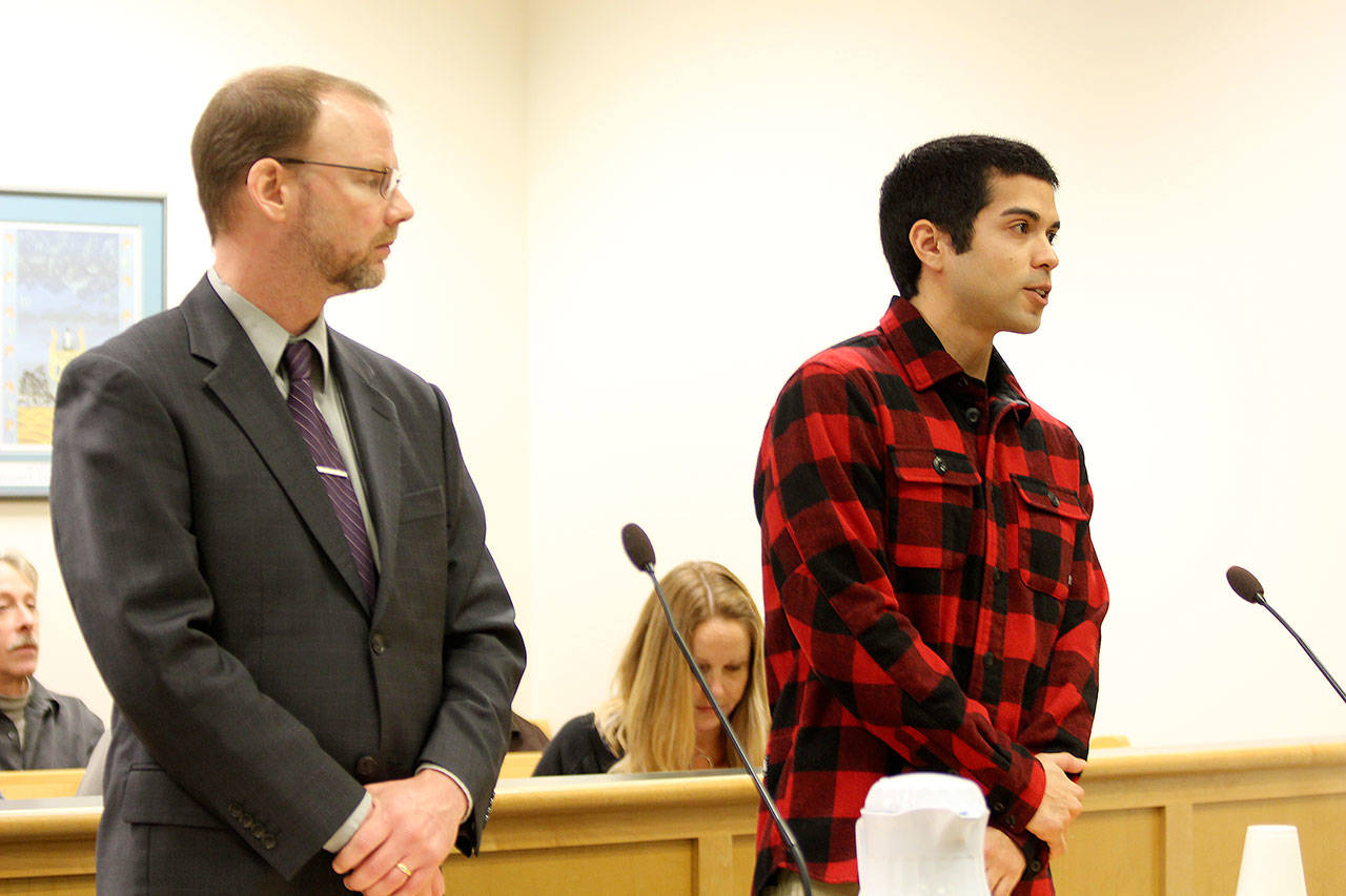 Photo by Jessie Stensland/Whidbey News-Times                                Oak Harbor resident Jon Johnson, at right, appears in Island County Superior Court Jan. 8 with attorney David Carman. Johnson is accused of videotaping himself assaulting a homeless man.