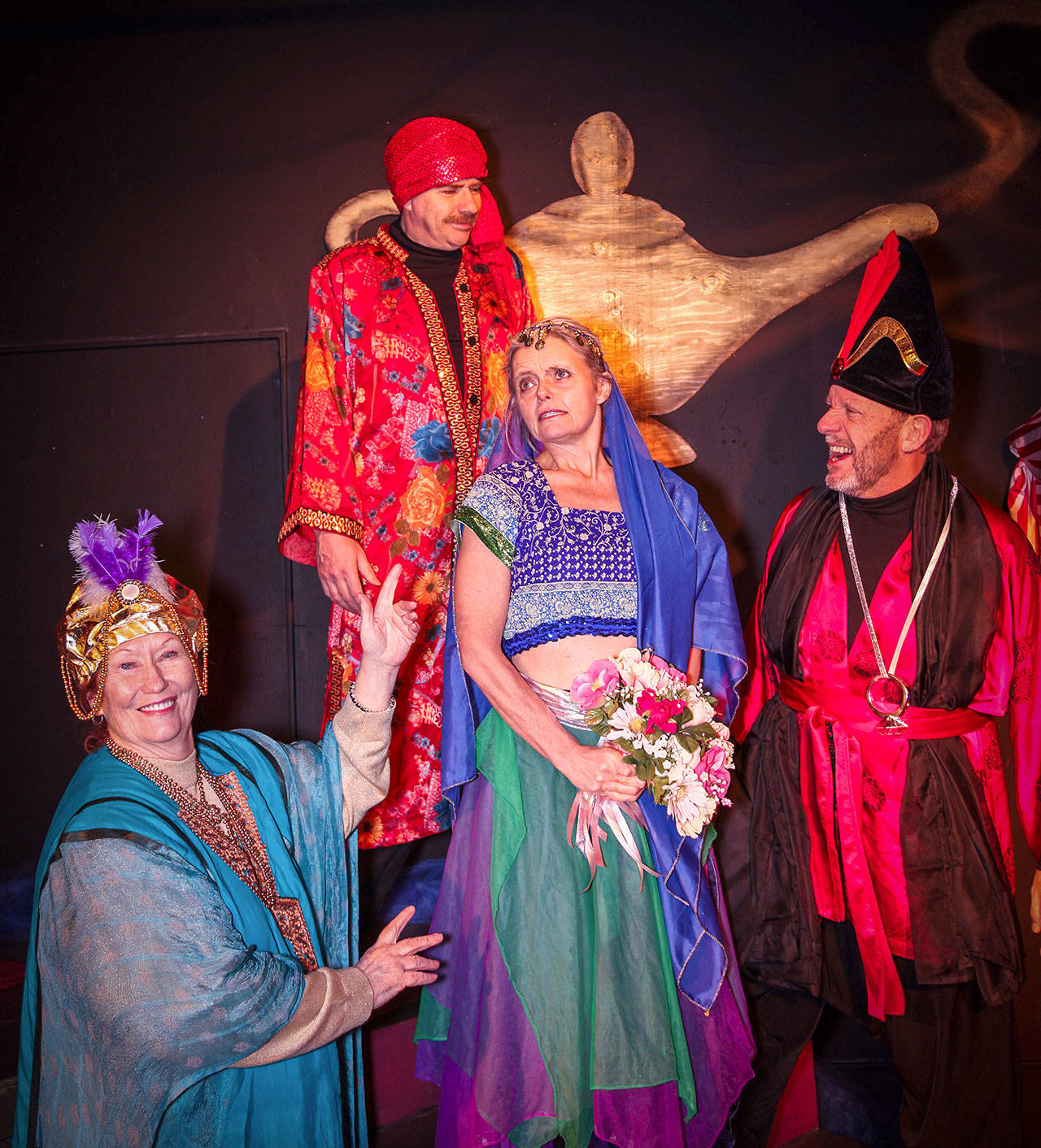 The Never Too Late Players rehearse for “Aladdin.” Annie Horton (left) plays the Genie, Matthew Wilson (back row) is the Emperor, Kim Wetherell (center) is Princess Jasmine and Jim Carroll plays Abanazer. Photo provided