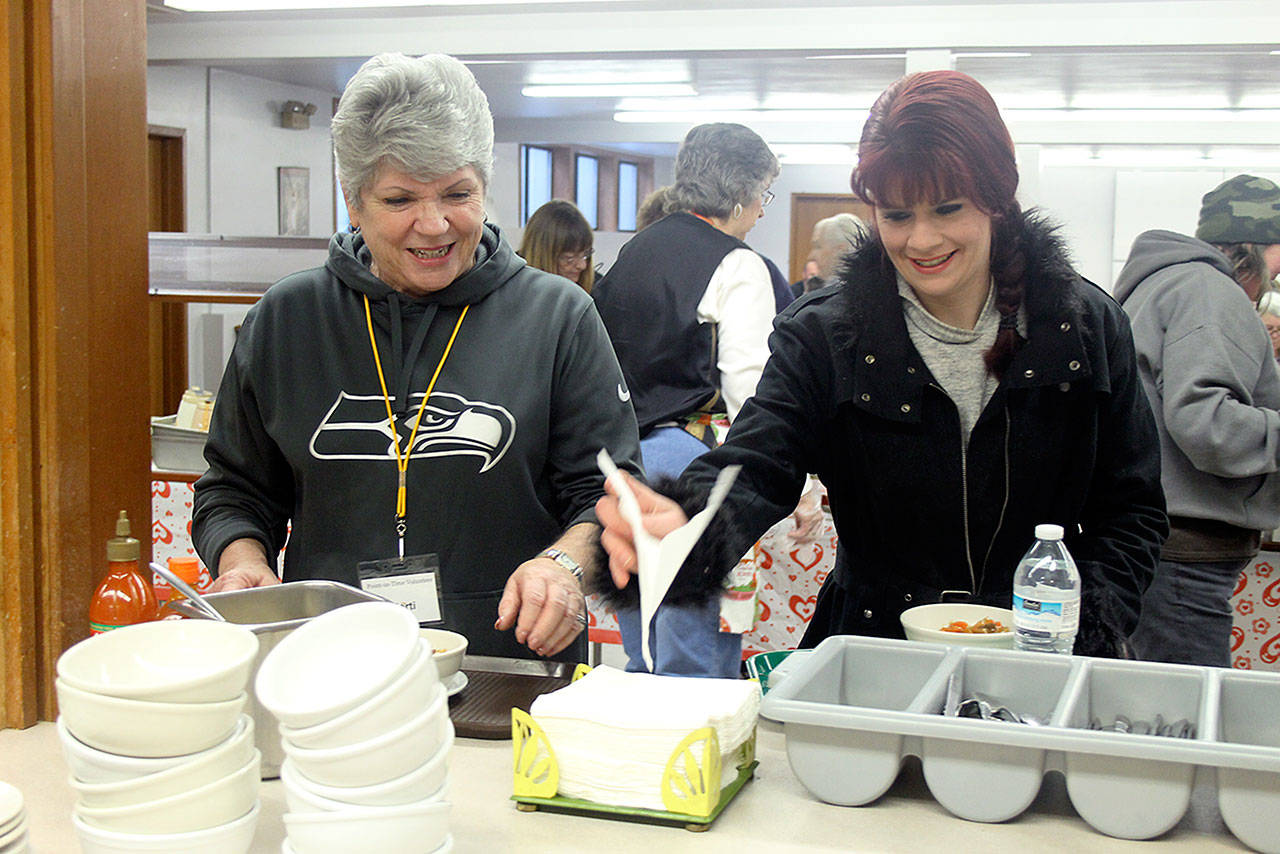 Evan Thompson / The Record  Whidbey Homeless Coalition board member Marti Bauer (left) and Natasha Hamblin eat lunch during the annual Island County Point in Time count on Thursday at Island Church in Langley. Hamblin, 29, is homeless.