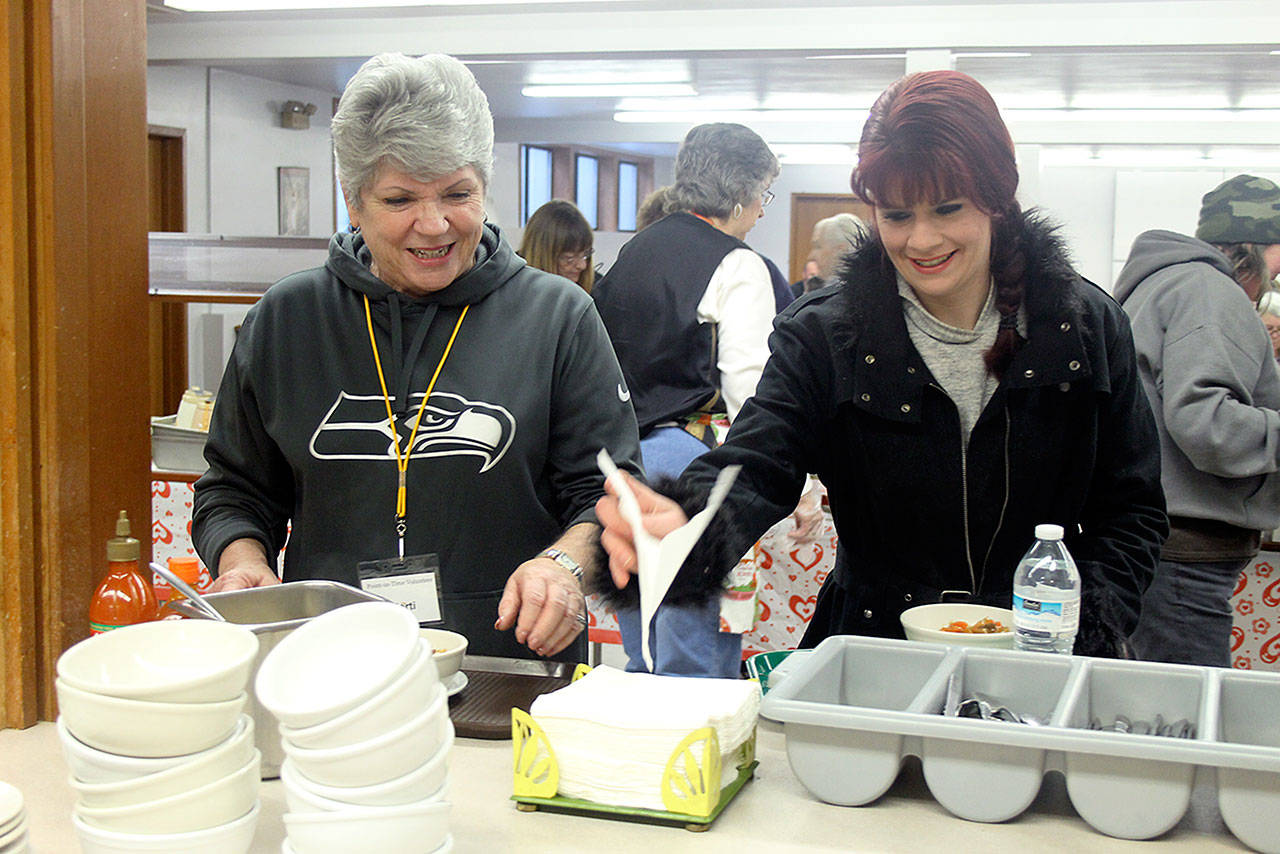 Evan Thompson / The Record — Whidbey Homeless Coalition board member Marti Bauer (left) and Natasha Hamblin eat lunch during the annual Island County Point in Time count on Thursday at Island Church in Langley. Hamblin, 29, is homeless.