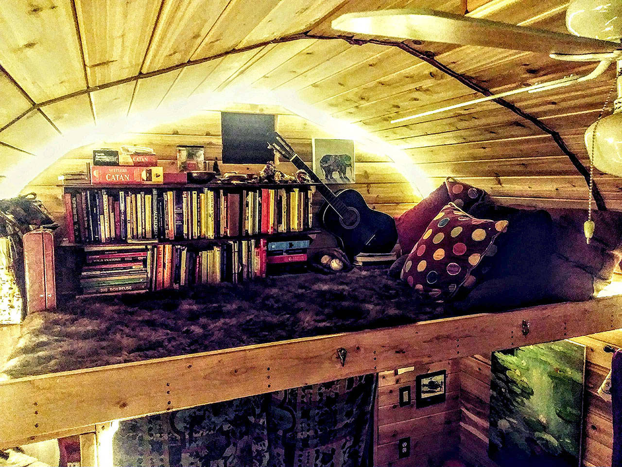 Contributed photo — Though small compared to normal sized houses, tiny homes offer flexibility and design creativity. The loft of a tiny home in Olympia is used for both sleeping space and a book shelf.