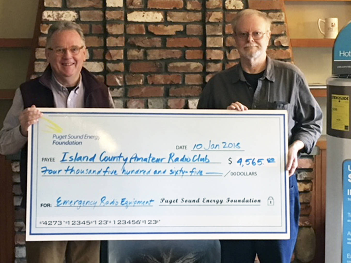 Contributed photo                                Walt Blackford (left), Puget Sound Energy regional outreach manager, presented a grant of $4,565 from the Puget Sound Energy Foundation to John Acton of the Island County Amateur Radio Club (ICARC).