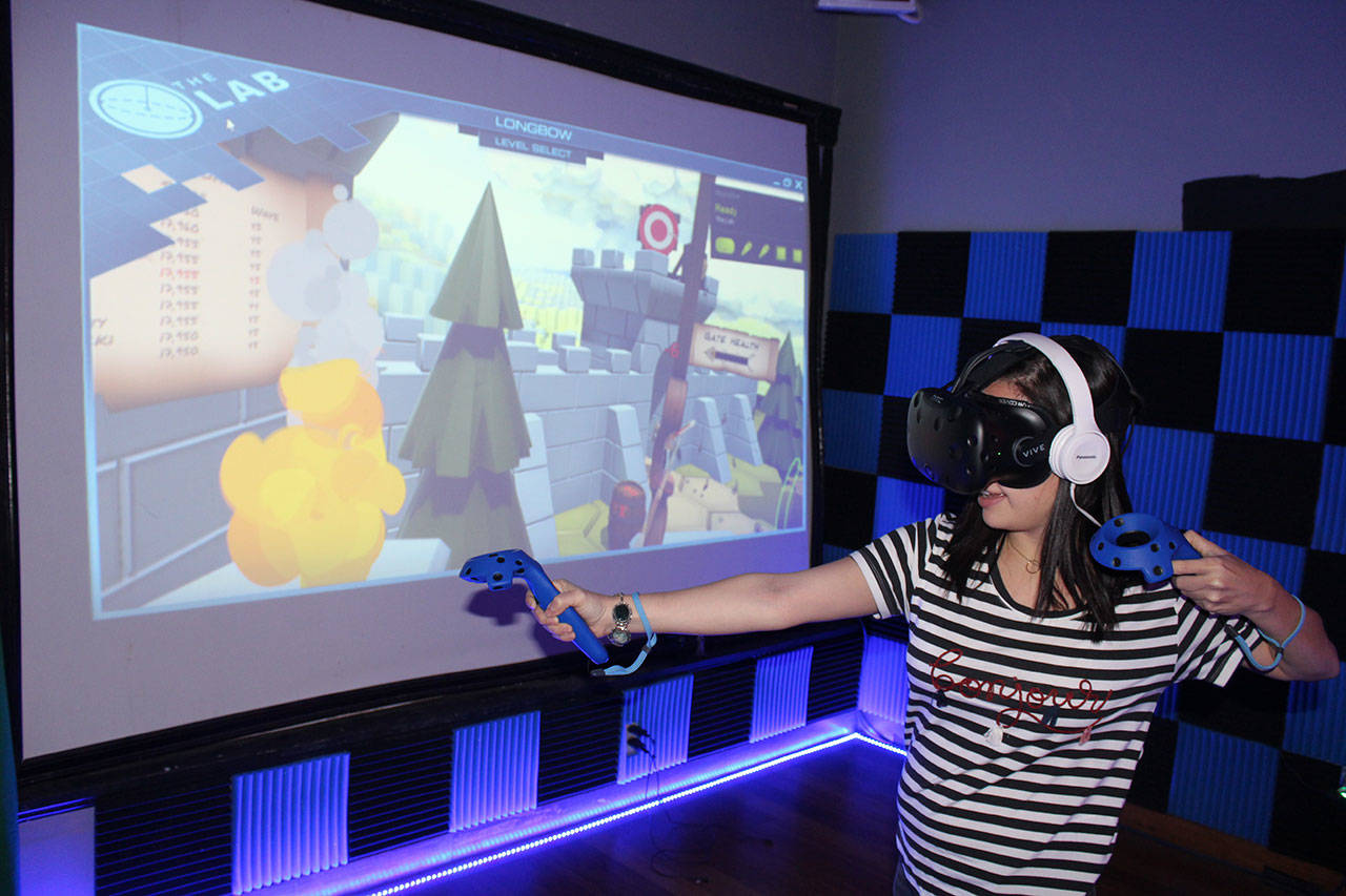 Silvana Iosve recently donned Holodeck Virtual Reality gear and shot arrows at marauding Vikings at the Machine Shop in Langley. Photos by Patricia Guthrie/Whidbey News Group
