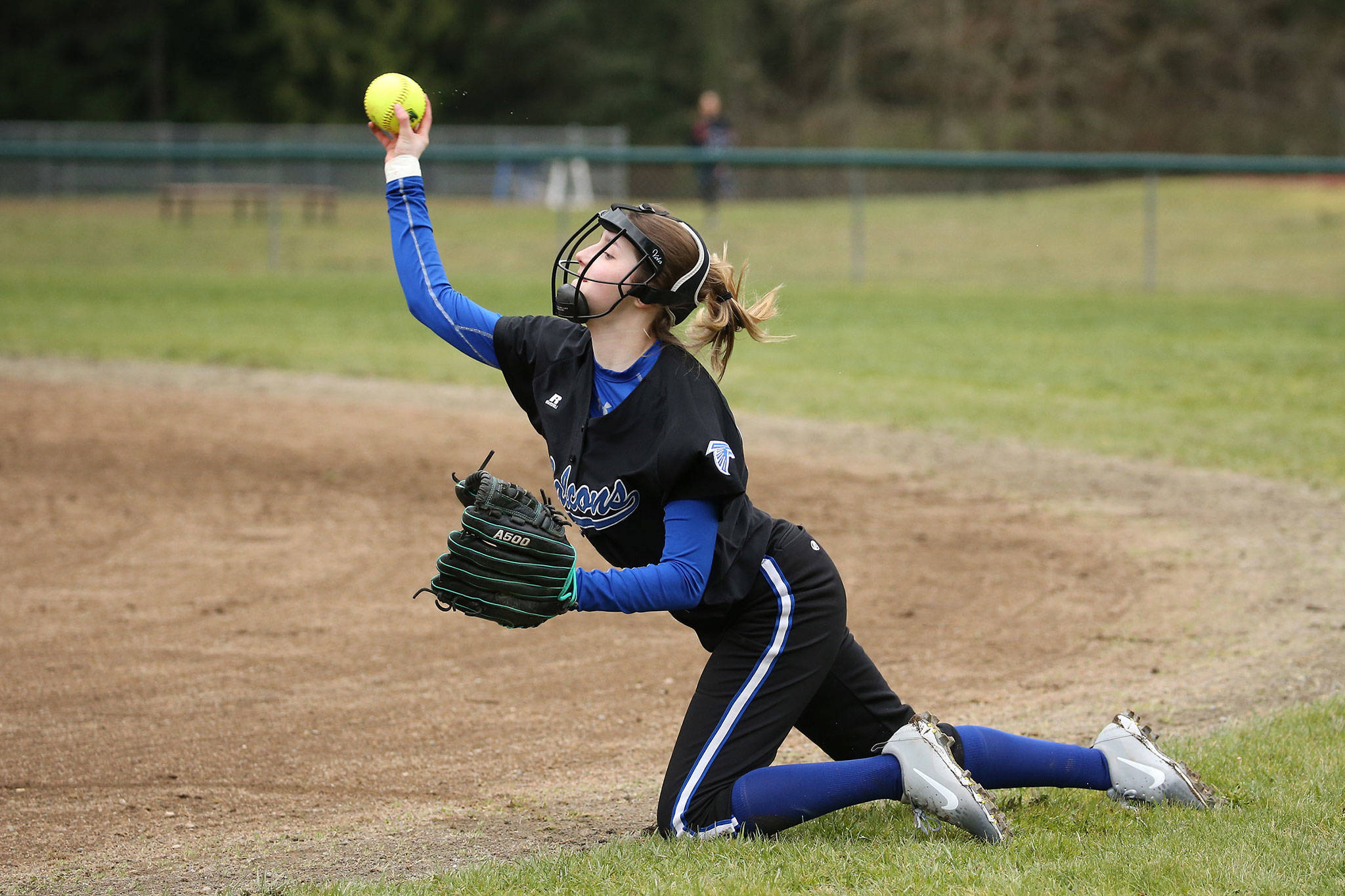 South Whidbey second baseman Myah Majestic throws to first from her knees after making a stop. (Photo by John Fisken)