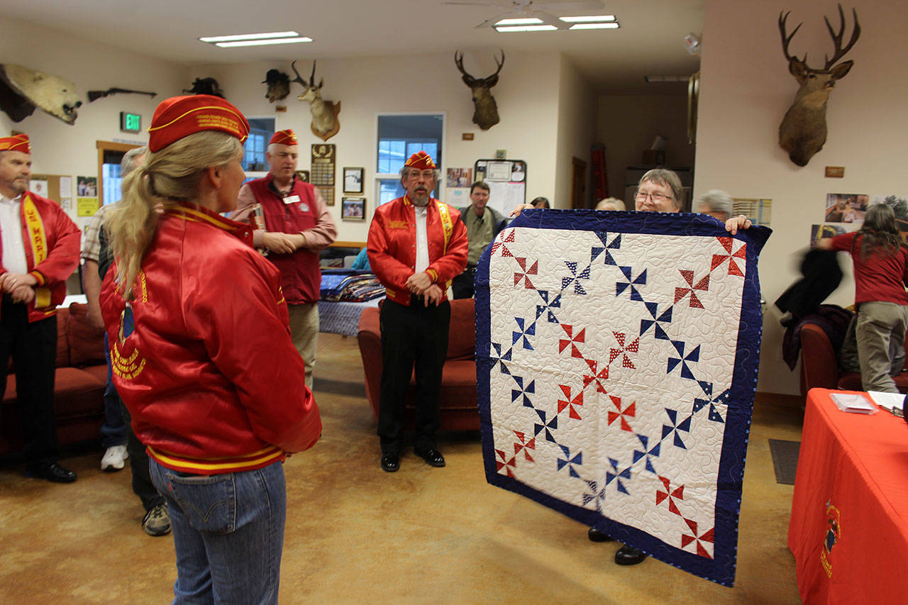 “M. J.” Margaret Johns receiving her quilt from Anita Smith. Photos by Patricia Guthrie/Whidbey News Group