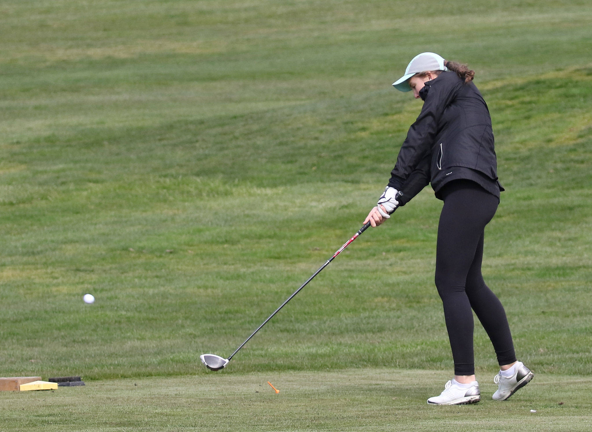 Emma Leggett tees off in the Shootout at the Whidbey Golf Club in Oak Harbor Tuesday. (Photo by John Fisken)