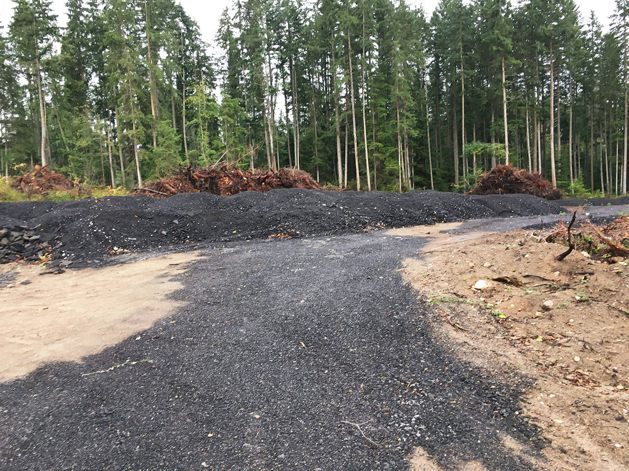 Piles of ground asphalt on a property on Midvale Road. Photo provided