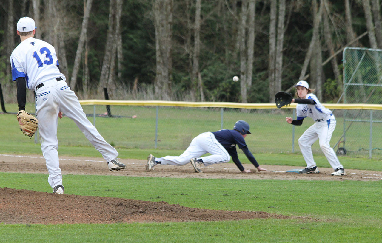 Falcon pitcher Drew Fry throws to Nick Young in an attempt to pick off a CPC runner.(Photo by Jim Waller/Whidbey News Group)