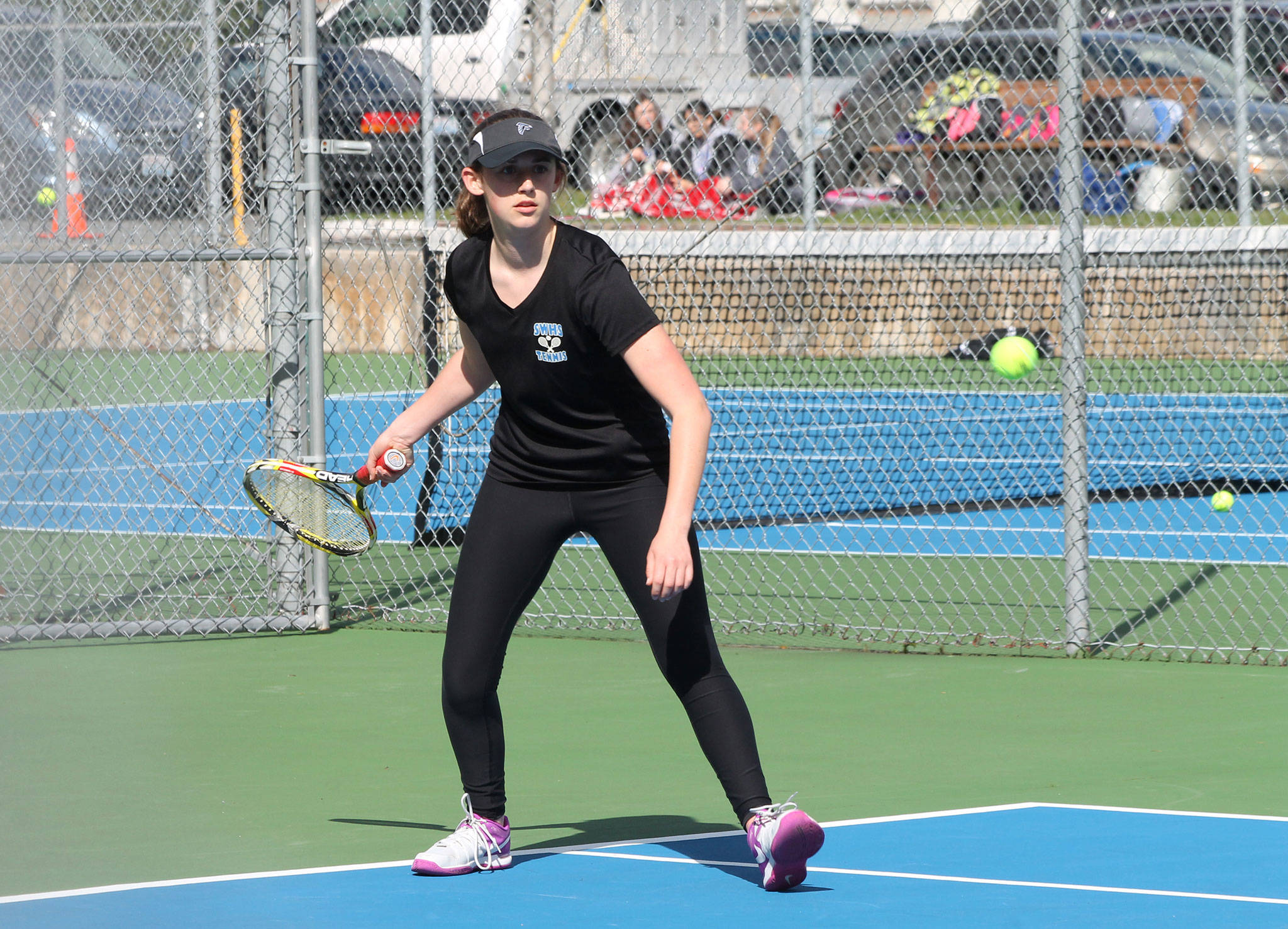 Ashley Ricketts returns a shot in her second singles match against Oak Harbor Thursday. (Photo by Jim Waller/Whidbey News Group)