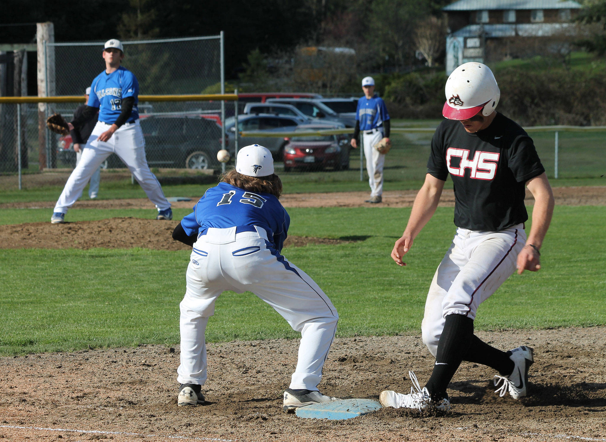 Falcon pitcher Brent Batchelor throws to first baseman Nick Young in an attempt to pick off Cedarcrest’s Aaron Davenport.(Photo by Jim Waller/Whidbey News Group)