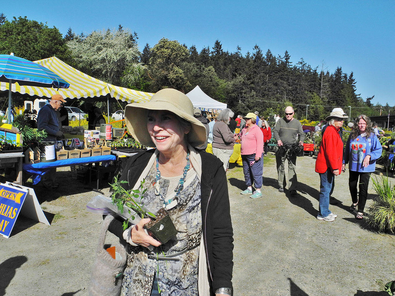 A happy customer leaves the 2017 plant sale of South Whidbey Garden Club. On April 28, the club’s annual sale will be indoors for the first time at Bayview Community Hall. Photo provided
