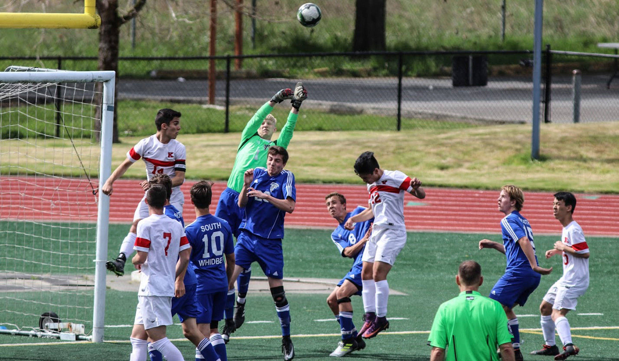 Julian Inches (green jersey) and the South Whidbey defense stops a Kings attack in the district championship match.(Photo by Erin Simms)