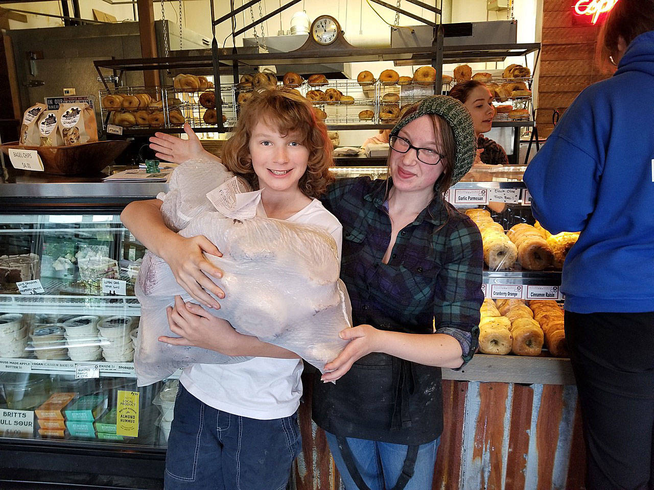 Spencer Jones got some help from Alex Hurt managing a large and heavy bag of fresh bagels donated by John Auburn of the Bagel Factory in Clinton. The bagels were picked up on the day of the food drop-off for maximum freshness. Photo provided