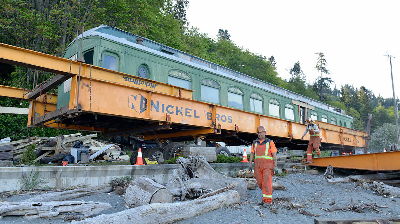 Nickel Bros workers move the parlor car from its shelter to the ship which will carry it across the water. Courtesy Photo