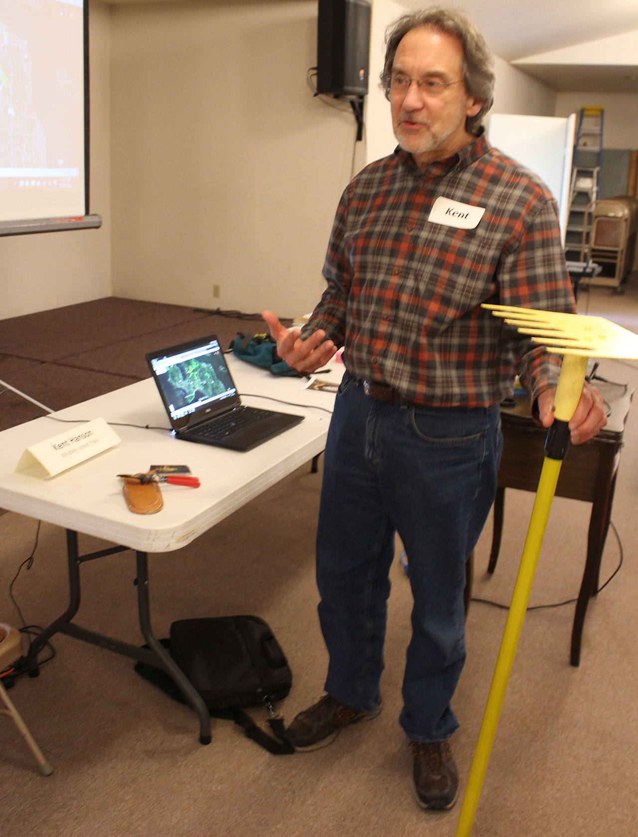 Kent Hanson shows off the two simple tools he says are needed to make hiking trails  a garden snip and a rake called a McLeod. Photo by Patricia Guthrie/Whidbey News-Group