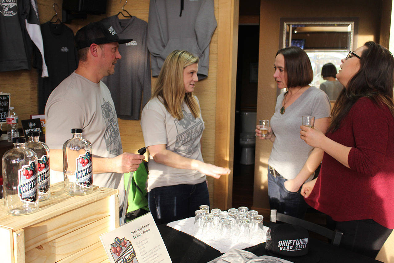 Jake and Lindsay Krug talk to customers trying out their Driftwood Hard Cider during a spring tasting. It’s currently served at three Whidbey bars and restaurants. Photo by Patricia Guthrie/Whidbey News Group