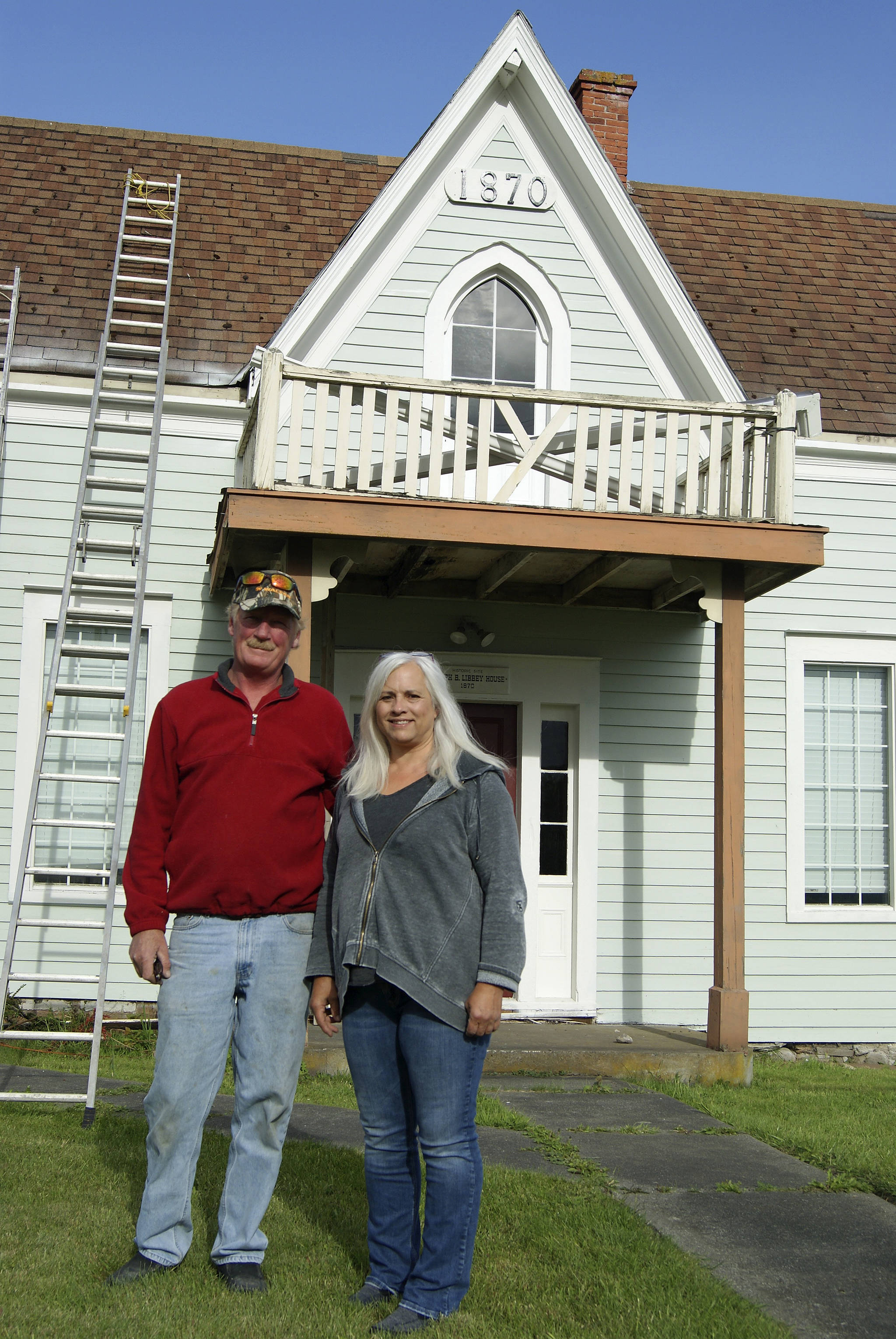 Dennis McCaslin and Cindy Balthazar stand in front of the Joseph B. Libbey House, a historic structure built in 1870 that new owner McCaslin is working to restore. “We’re going to save it,” he said.