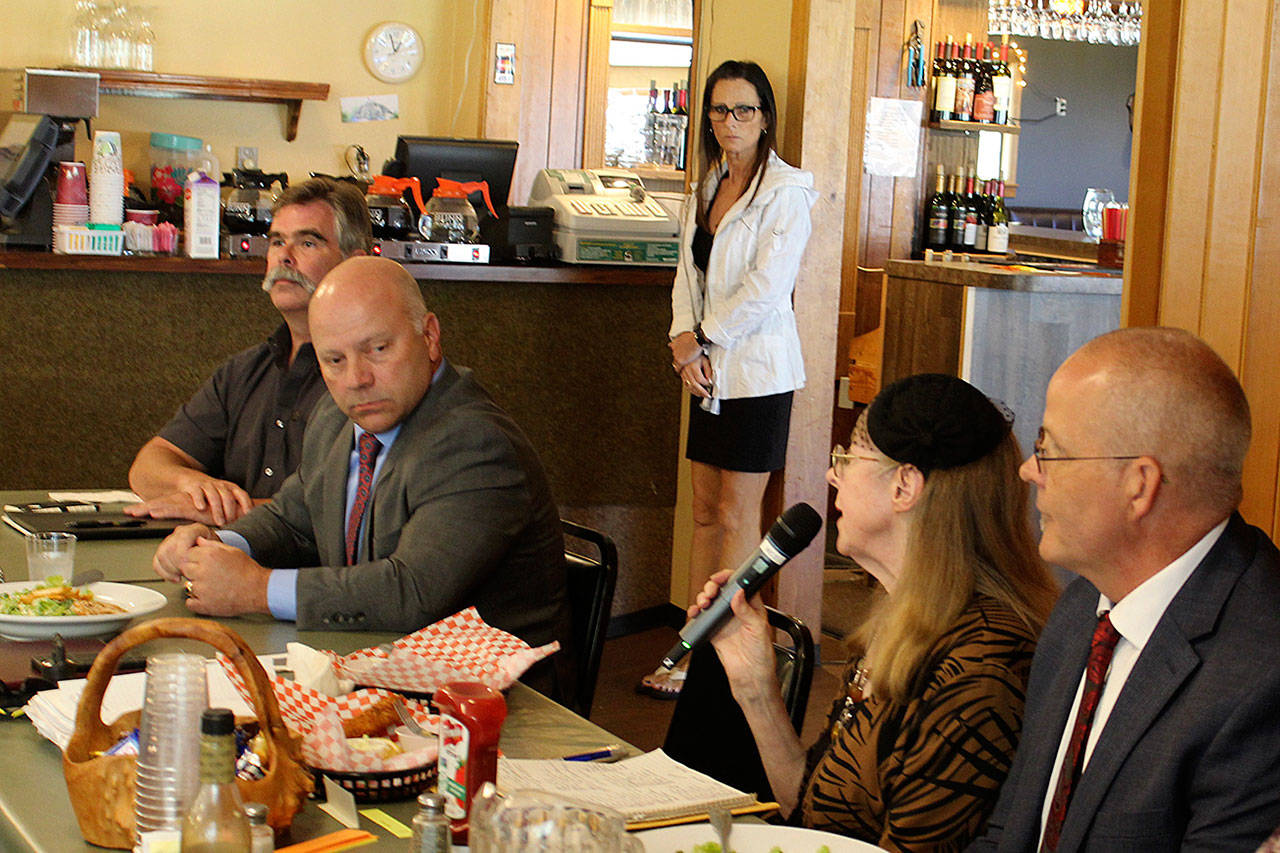 Reece Rose starts Friday’s forum with sheriff candidates Rick Felici (second from left) and Lane Campbell (right) who answered questions during a luncheon at Holmes Harbor Rod & Gun Club. Photo by Patricia Guthrie/Whidbey News Group