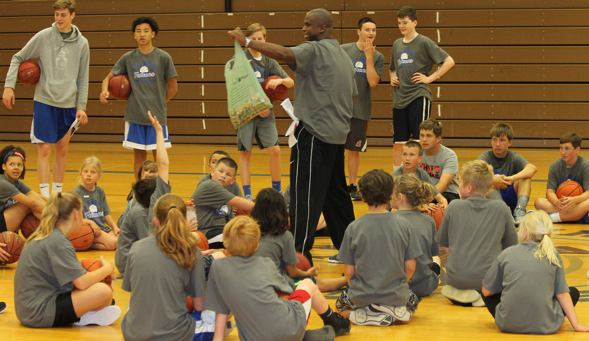 South Whidbey High School boys basketball coach offers candy to campers who can demonstrate specific skills.(Photo by Jim Waller/South Whidbey Record)