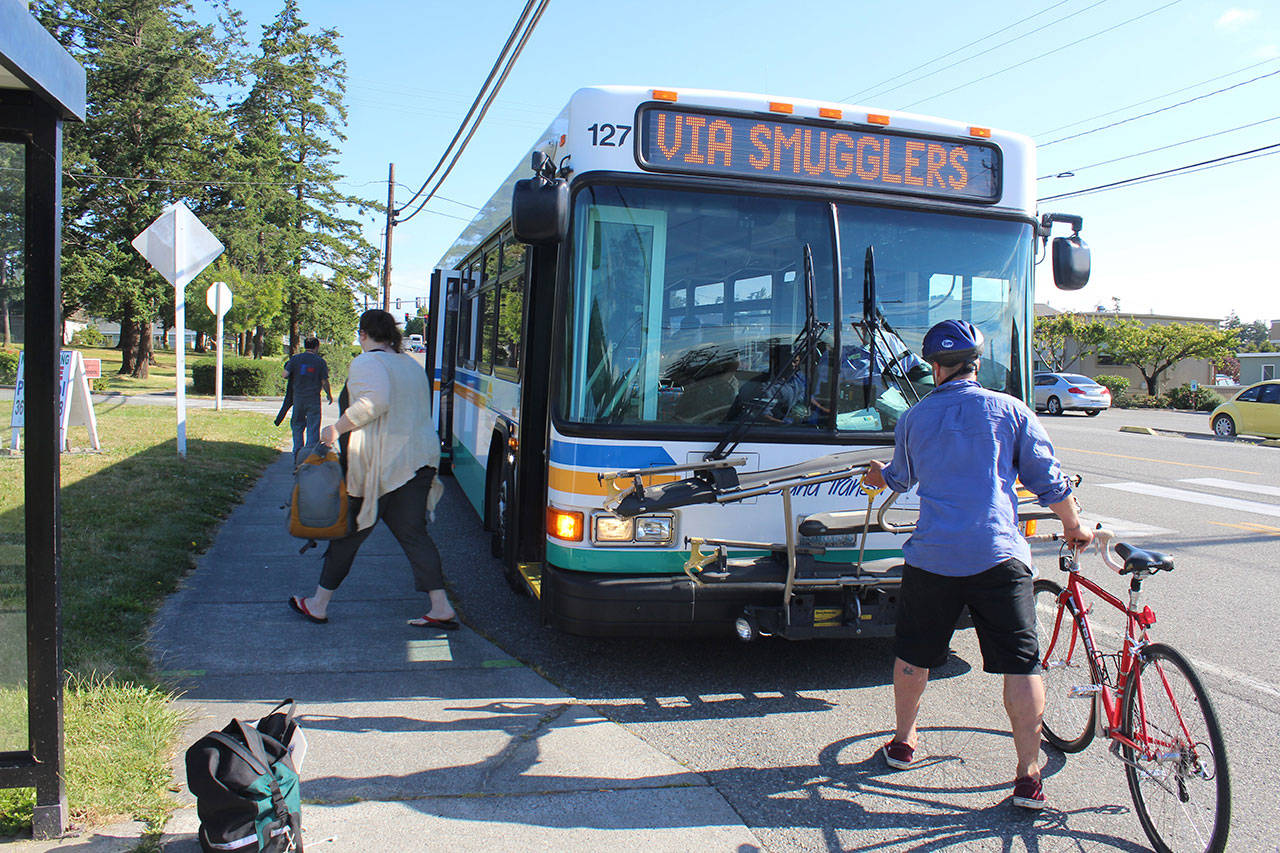 Passengers get off and on in Coupeville on a southbound Island Transit bus Tuesday morning. The transit system’s board voted against charging fares. Photo by Patricia Guthrie/Whidbey News Group