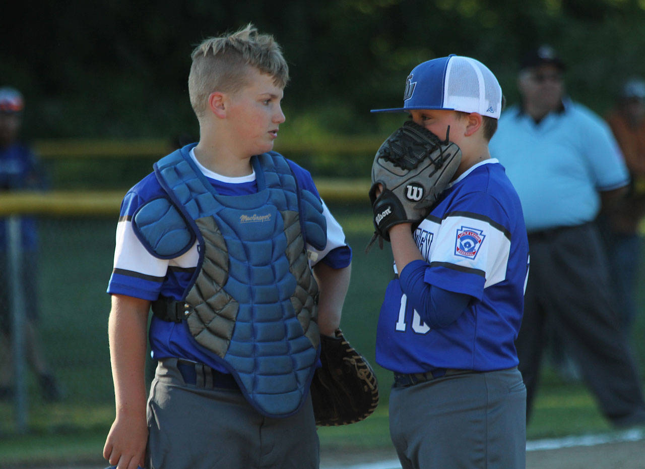 Catcher Cole Thorsen and pitcher Liam Petty meet on the mound Tuesday.(Photo by Jim Waller/South Whidbey Record)