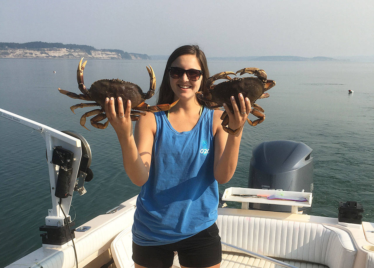 Coupeville resident Kelsey Miranda holds up two of her catches last summer. Crabbing season opens Saturday and Island County Marine Resources Committee and Northwest Straights Foundation are providing tips to prevent losing crab pots. Photo provided.