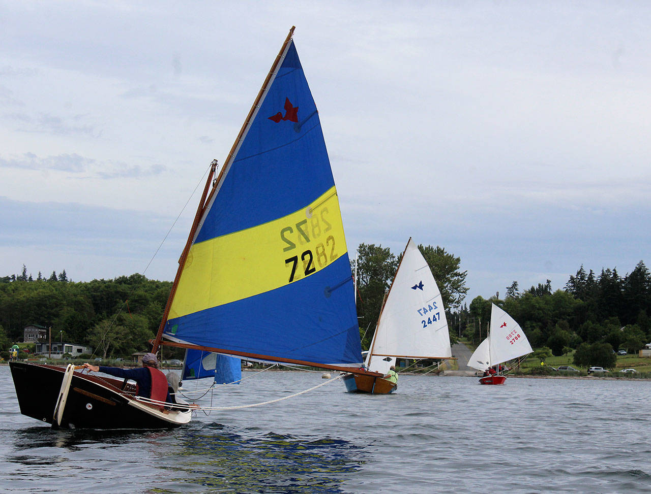 Three Pelican class sailing boats line up as they head for a buoy during an evening race of the South Whidbey Yacht Club. Photo by Patricia Guthrie/Whidbey News Group