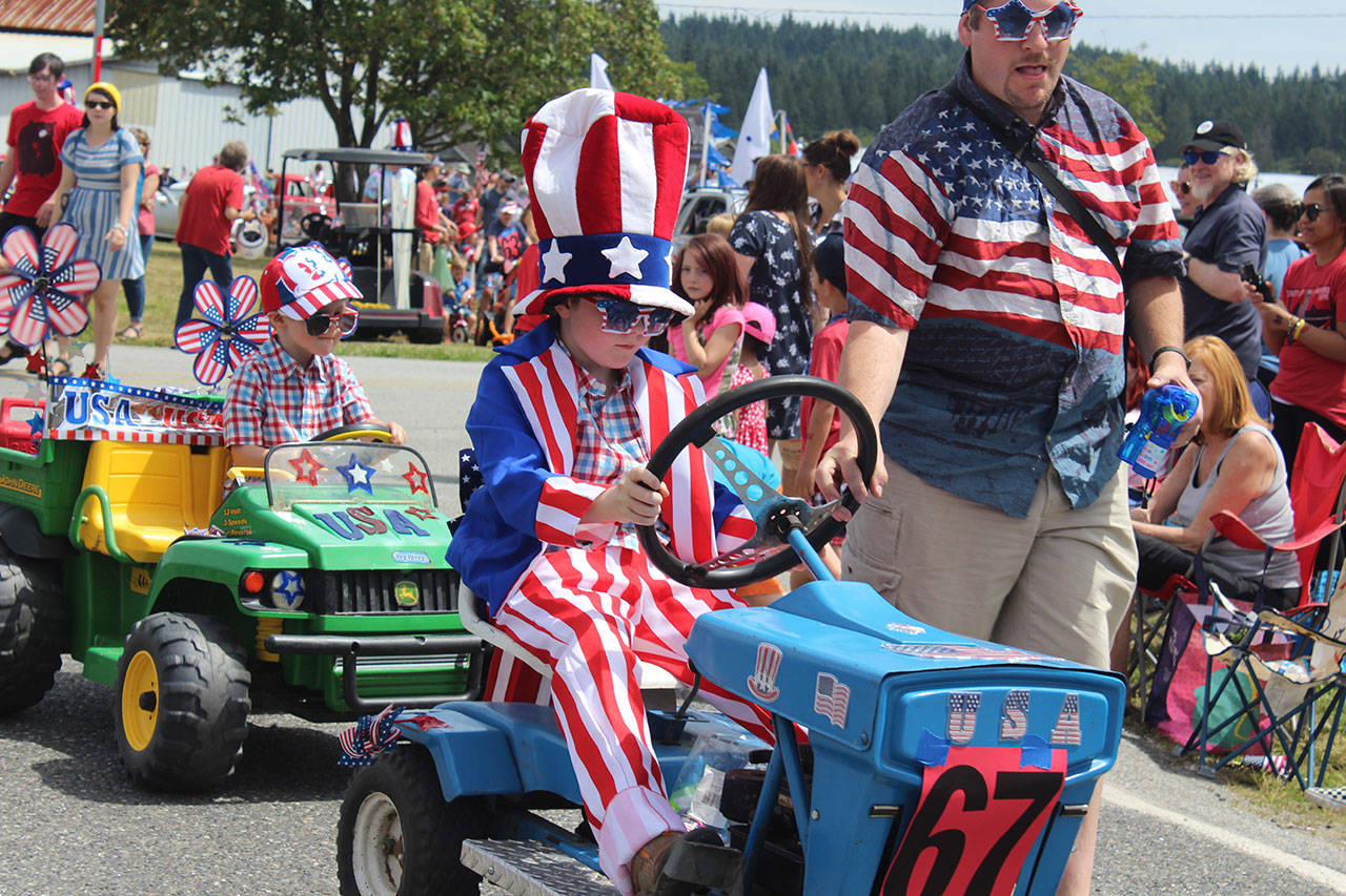 All types of vehicles and groups were part of the popular Maxwelton 4th of July Parade in South Whidbey. Thousands turned out under sunny skies for the red, white and blue event that celebrated its 103rd year.                                Photo by Patricia Guthrie/Whidbey News Group