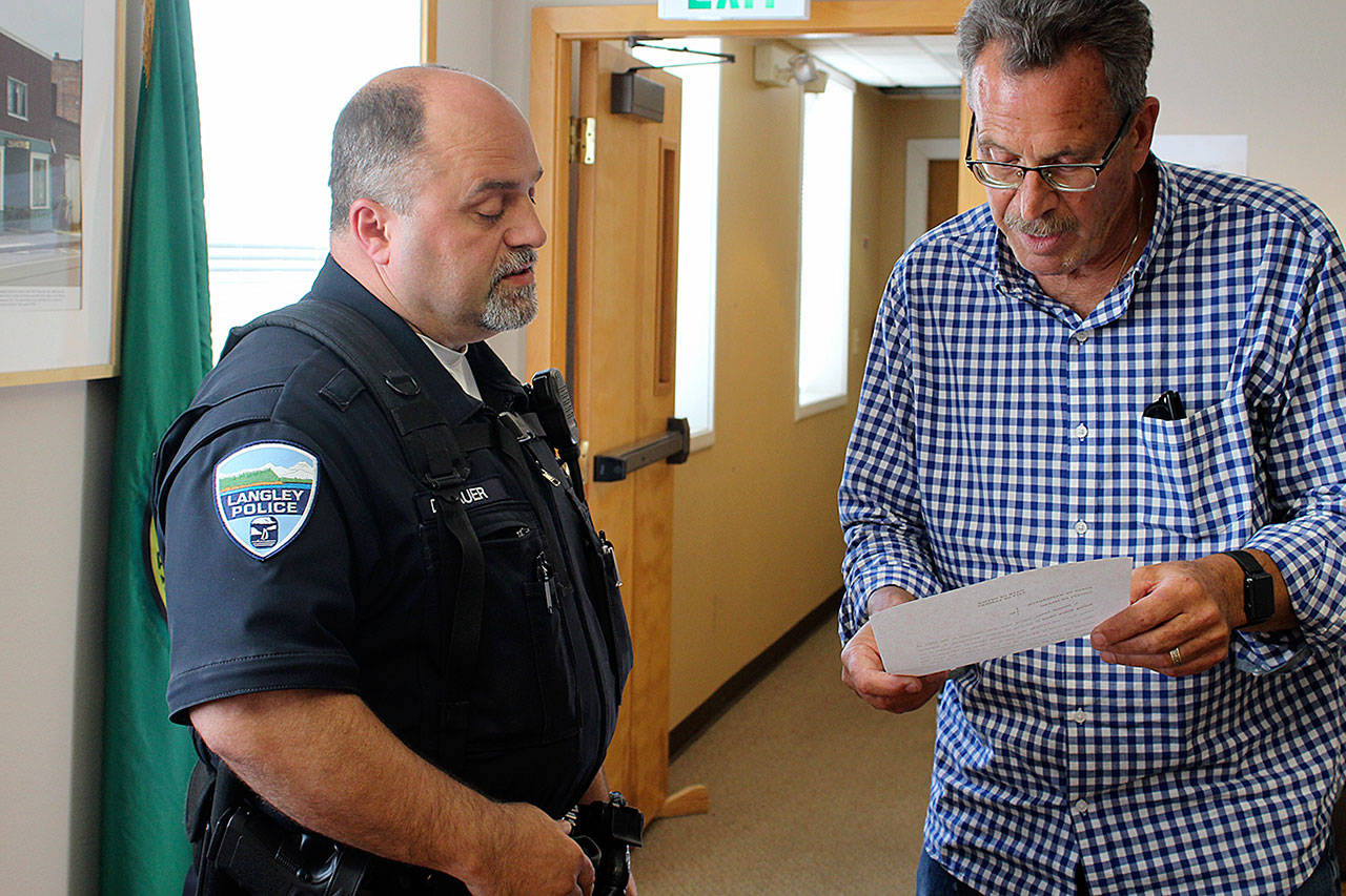 Officer Don Lauer is sworn in as acting police chief by Langley Mayor Tim Callison. Photo by Patricia Guthrie/Whidbey News Group