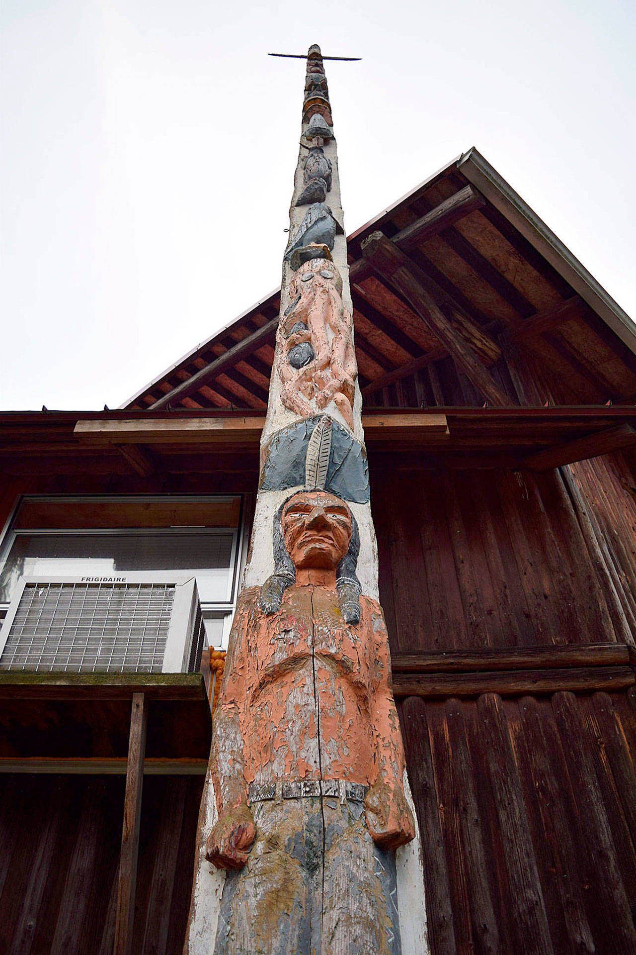 The story pole at Island County Fairgrounds has greeted thousands of visitors for more than 70 years. But who carved it and how and when it ended up at the fair is a mystery that the South Whidbey Historical Society is trying to solve. File photo