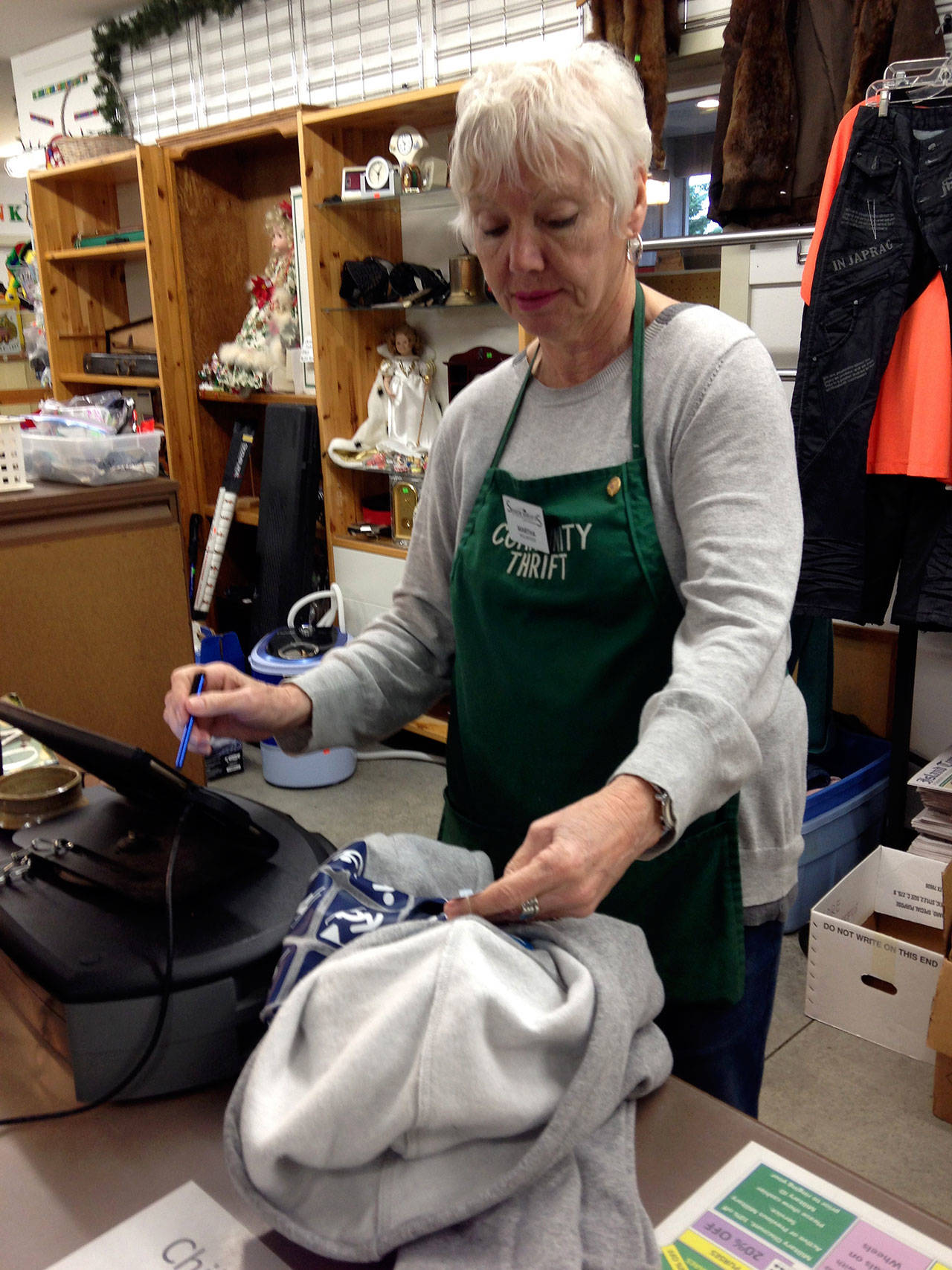 A volunteer rings up a purchase at Senior Thrift, which is operated by Island Senior Resources as a revenue source to support its numerous programs and services. The nonprofit agency’s “Together We Care,” campaign is attempting to raise $10,000 on Aug. 1. (Photo provided)