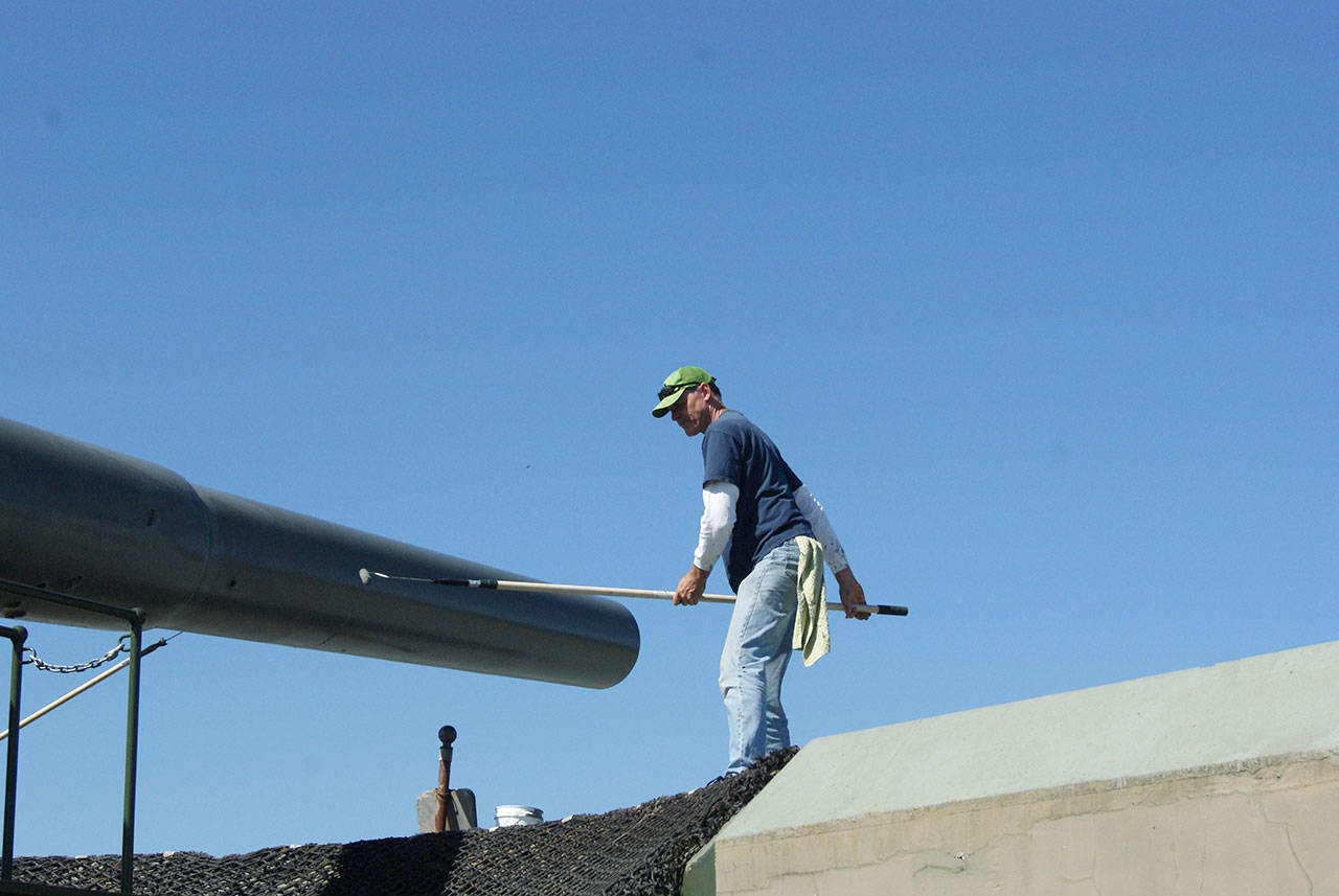 Photos by Maria Matson/Whidbey News Group                                John White of Freeland works to paint the “Big Guns” at Fort Casey. It was a good day to paint, with the sunshine and fresh air, he said. The work is being done by volunteers in preparation of the 50th anniversary of the “Big Guns” arrival, which will be held on Aug. 11.