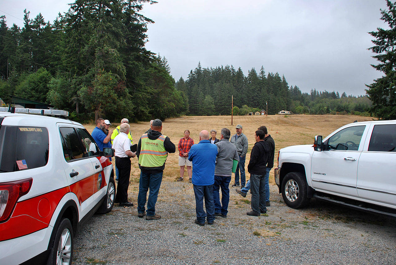 Photo provided                                Representatives from South Whidbey Fire/EMS, Island County, Valdez Construction, Carletti Architects and Good Cheer gather with the future fire station site in the background.