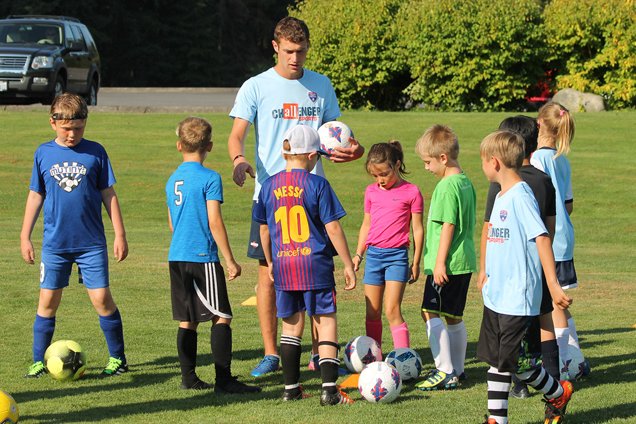 Coach Owin Whelan organizes the first drill at the South Whidbey soccer camp Thursday. (Photo by Jim Waller/South Whidbey Record)