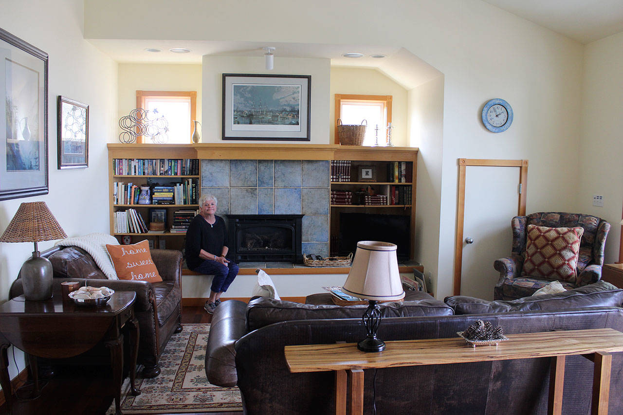 Susanne Paulson sits in the living room of the two-bedroom apartment, “The Carriage House,” above her garage that she rents out to Langley visitors. Located on First Street, downtown is just a block away. Photo by Patricia Guthrie/Whidbey News Group