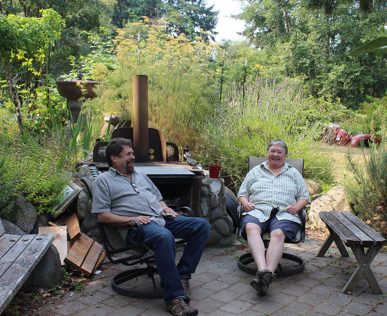 Bruce Morrow and Buffy Cribbs enjoy the outdoor patio at their South Whidbey home they built together.