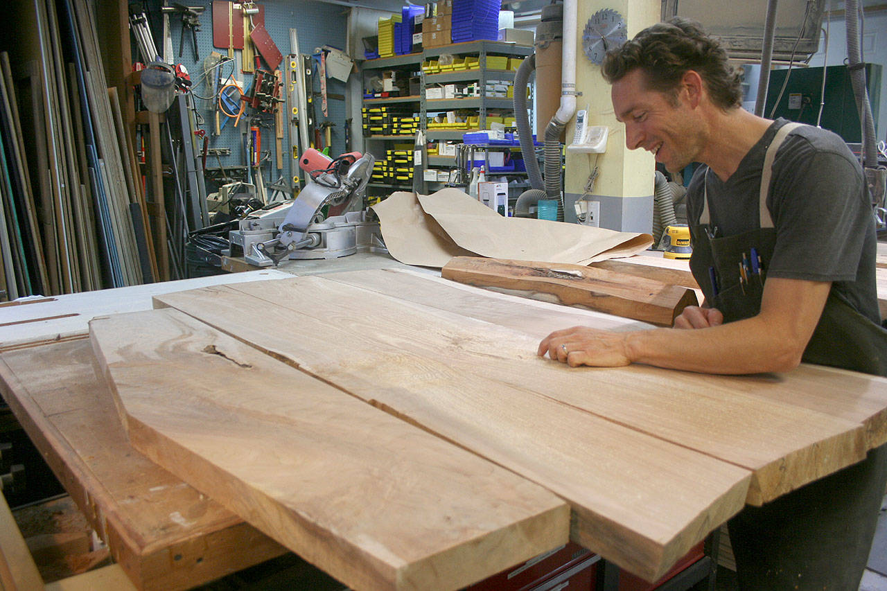 Photo by Emily Gilbert / Whidbey News-Times                                &lt;em&gt;Glen Pearson inspects the Maple wood slabs that will become the top of the table he’s making for Woodpalooza this year. He said it’ll take him about 60 hours to have the table finished.&lt;/em&gt;