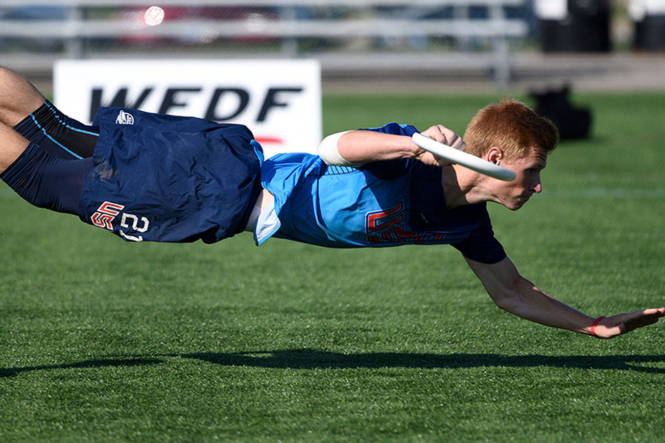 Conner Ryan dives for the disc at the World Junior Ultimate Championships held in Canada. Photo by Ulti Photos.