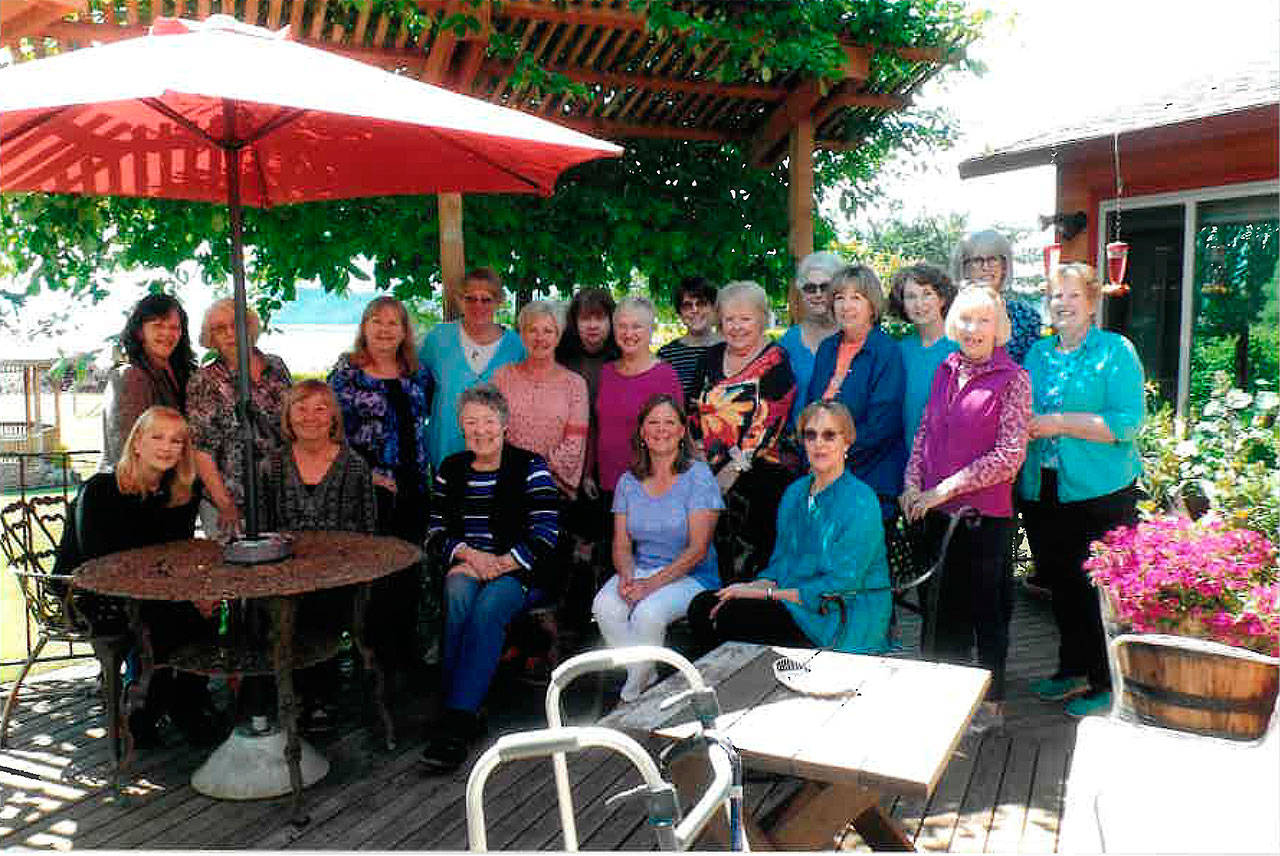 Photo submitted                                Members of the South Whidbey Nightcrawlers Garden Club pose for a photo on Janie Gabelein’s deck in June. The organization is celebrating its 38th anniversary.